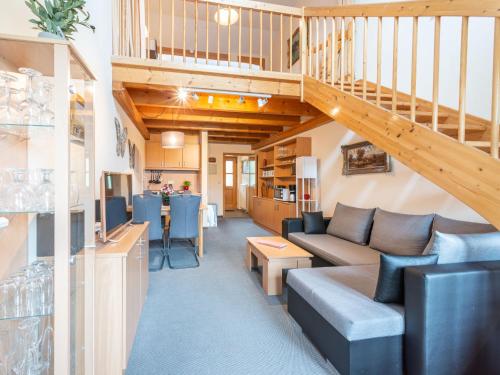 a living room with a couch and a staircase at Apartment Am Hohen Bogen-6 by Interhome in Arrach
