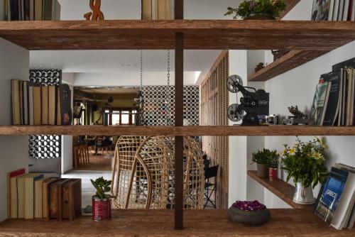 a room with wooden shelves with books at Chris Hotel in Skala