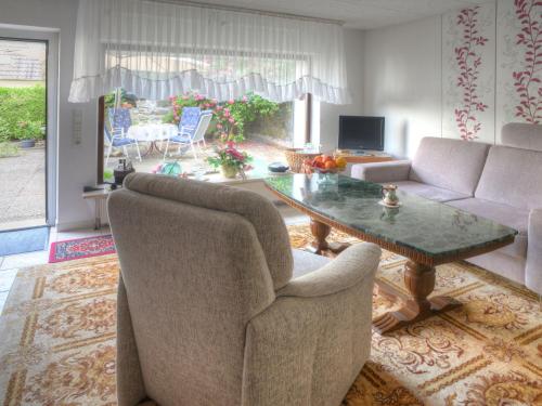 a living room with a table and two chairs at Apartment Am Dohlenberg by Interhome in Schieder-Schwalenberg