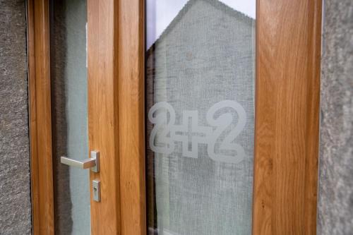 a glass door with the on it at Bed & Bike La Stalla in Masera
