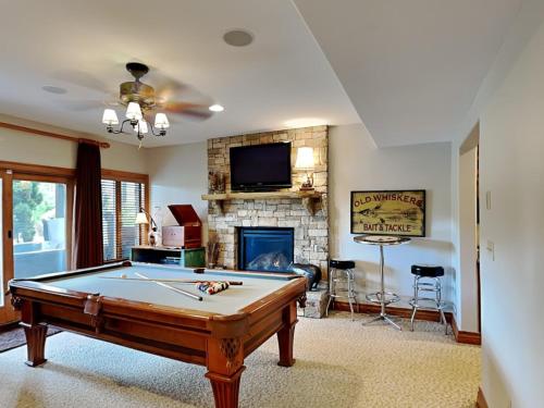 a living room with a pool table and a fireplace at At the Start of It All in McHenry