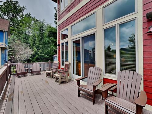 a wooden deck with chairs and windows on a house at At the Start of It All in McHenry