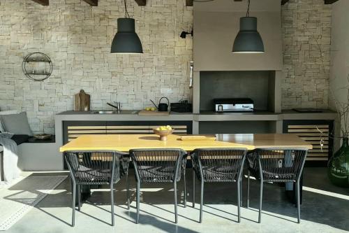 a kitchen with a wooden table and chairs at Villa ZAZ in Heki