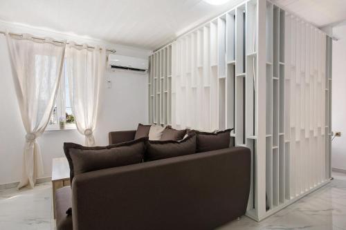 a living room with a couch and some windows at Villa Drosia in Volimes