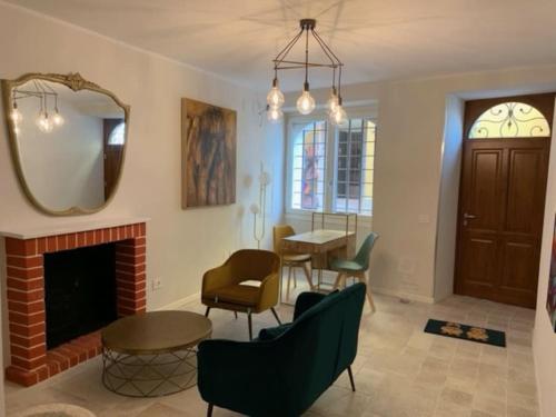 a living room with a fireplace and a mirror at Locanda Carolina Mastino Scala in Sirmione