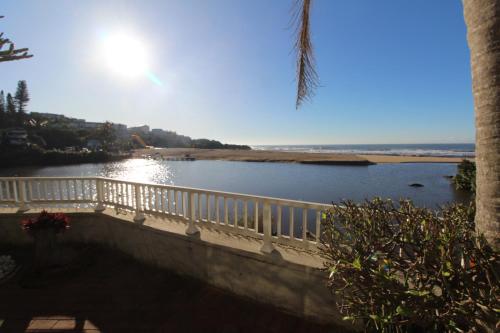 a bridge over a body of water next to a beach at Inn On The Sea 8 in Margate