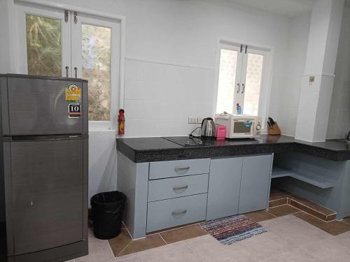 a kitchen with a refrigerator and a counter top at Reuan Phaolai in Bophut