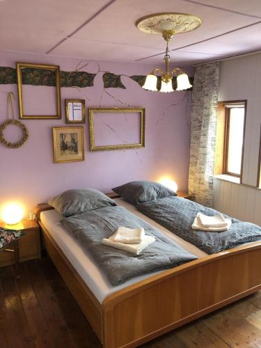 a large bed in a bedroom with two towels on it at Retro-Sonnenbring B&B in Sønderborg