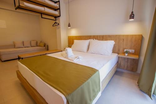 a bedroom with a large bed and a couch at Haus Riviera in Asprovalta