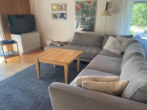 a living room with a couch and a coffee table at Holiday Home Herdina - 4km from the sea in NW Jutland by Interhome in Brovst