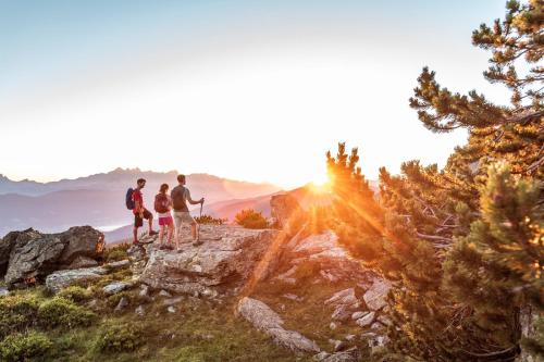 a group of people standing on a mountain at sunset at Alpenzeit in Flachau