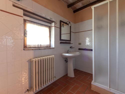 a bathroom with a sink and a toilet and a window at Holiday Home Le Calle by Interhome in Cinigiano