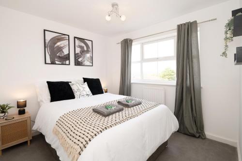 a bedroom with a white bed and a window at Modern 3BRhouse close to town with free parking in Kent
