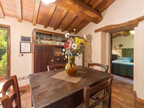 a vase of flowers on a wooden table in a room at Holiday Home Olinto by Interhome in Cinigiano