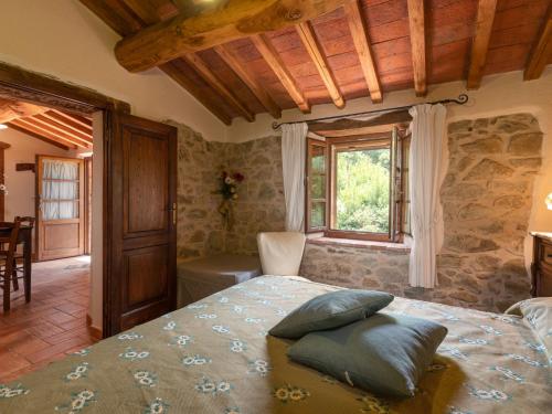 a bedroom with a bed with pillows on it at Holiday Home Olinto by Interhome in Cinigiano