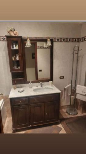 a bathroom with a sink and a large mirror at Maison Manni' B&B in Soverato Marina