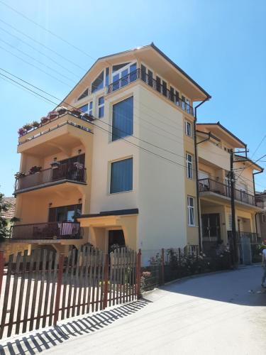 a building with a fence in front of it at City Park Rooms in Vranje