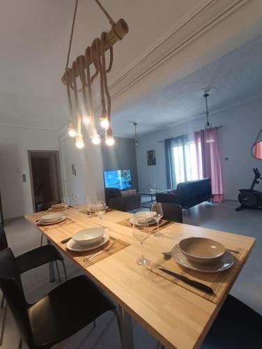 a wooden table with plates and wine glasses on it at House Of Diamond in Kírra