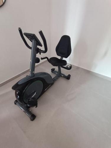 a exercise bike and a chair in a room at House Of Diamond in Kírra
