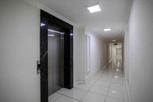 a hallway with a black door in a building at Chapel Towers 79 by CTHA in Cape Town