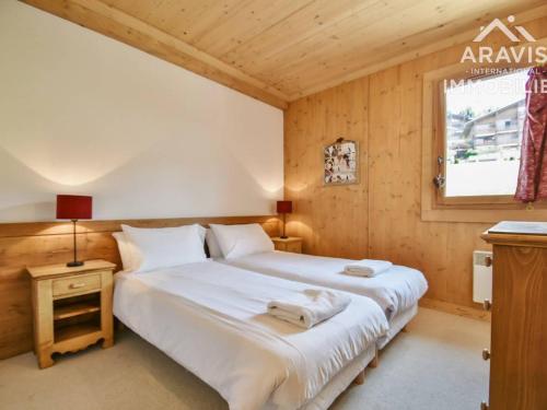 a bedroom with a large white bed and a window at Appartement Le Grand-Bornand, 3 pièces, 7 personnes - FR-1-391-97 in Le Grand-Bornand