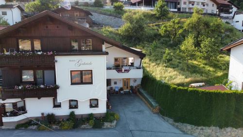 a house on a hill with a fence at Haus Gabriele in Ladis