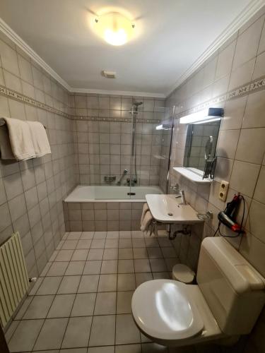 a bathroom with a tub and a toilet and a sink at Haus Gabriele in Ladis