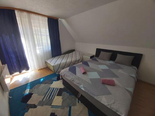 ein Schlafzimmer mit einem großen Bett und einem Fenster in der Unterkunft Orange House in Trnovo