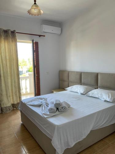 Hotel Xhelili في Cërrik: غرفة نوم عليها سرير وفوط