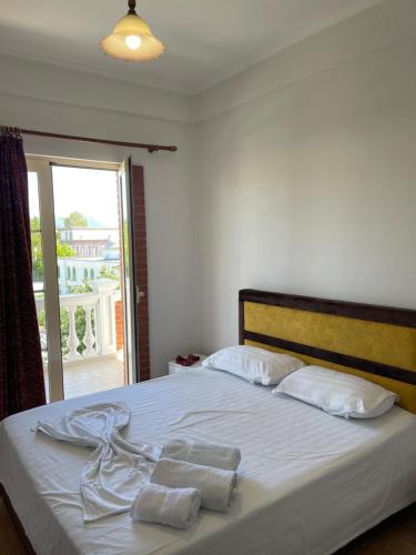 a bedroom with a bed with towels on it at Hotel Xhelili in Cërrik