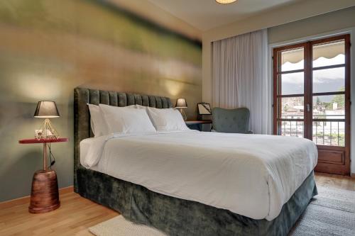 Un dormitorio con una cama grande y una ventana en Harmony villa - Ioannina castle, en Ioannina