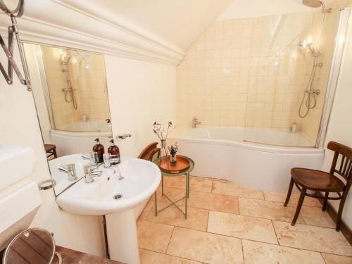 a bathroom with a sink and a bath tub at Chetwynd Lodge in Stafford