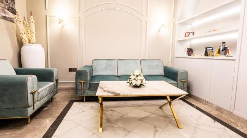 a living room with two blue chairs and a coffee table at President Hotel in Dubai