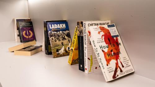 a group of books sitting on a shelf at President Hotel in Dubai