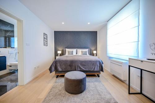 a bedroom with a bed and a large window at Apartments Lena in Malinska