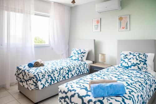 um quarto com 2 camas e uma janela em Narcissos 'Nissi Beach' Apartment E9 em Agia Napa