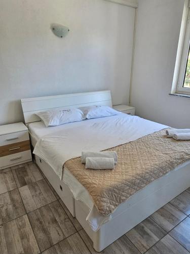 Postel nebo postele na pokoji v ubytování Apartmani Vuković