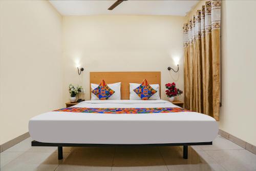 a bedroom with a large white bed in a room at FabHotel GK Residency in New Delhi