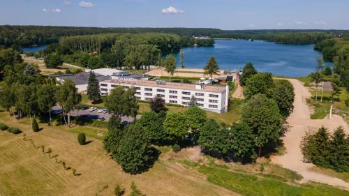 an aerial view of a resort with a lake at Omega Hotel in Olsztyn