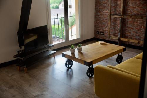 a living room with a coffee table and a fireplace at Alaimo et Les2Roses in Paray-le-Monial