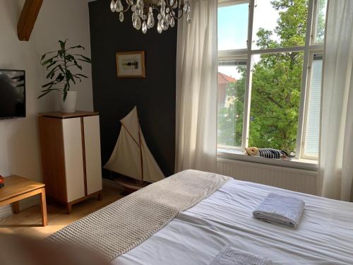 a bedroom with a bed and a large window at Stensö Room in Kalmar