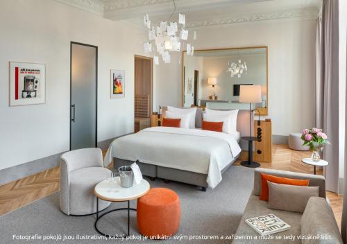 a bedroom with a large bed and a living room at Hotel BOOKQUET in Prague