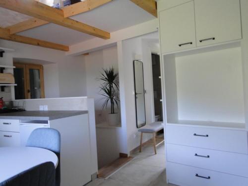 a room with a white kitchen with a sink and a mirror at Heritage 4-Stars Apartment Kyra Pitve Hvar in Jelsa