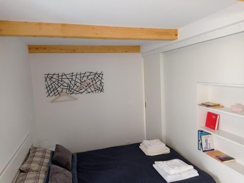a small room with a bed and a shelf at Heritage 4-Stars Apartment Kyra Pitve Hvar in Jelsa