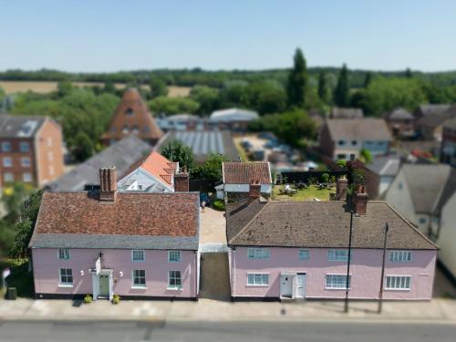 arial view of a town with a pink house at The Abbey Hotel & Apartments in Bury Saint Edmunds