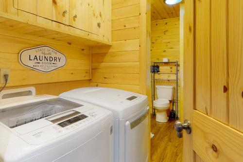 a laundry room with a washer and dryer in a log cabin at Peach Creek Lodge in Kiker