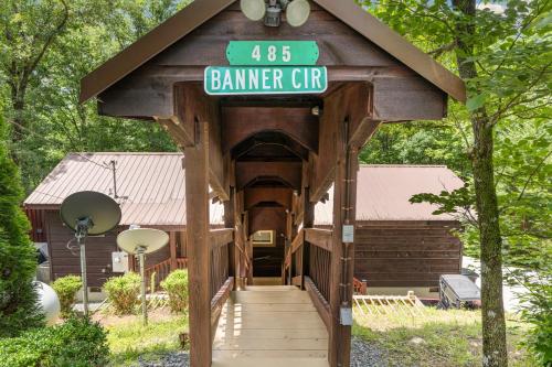a wooden covered bridge with a sign on it at Peach Creek Lodge in Kiker