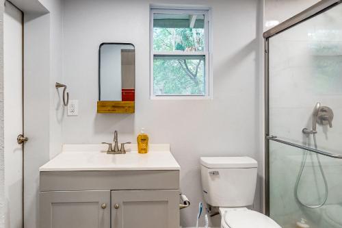 a bathroom with a toilet and a sink and a shower at Belleview Lakehouse in Ocklawaha