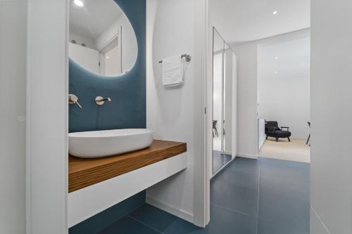 a bathroom with a white sink and a mirror at Paquja in Quartu SantʼElena