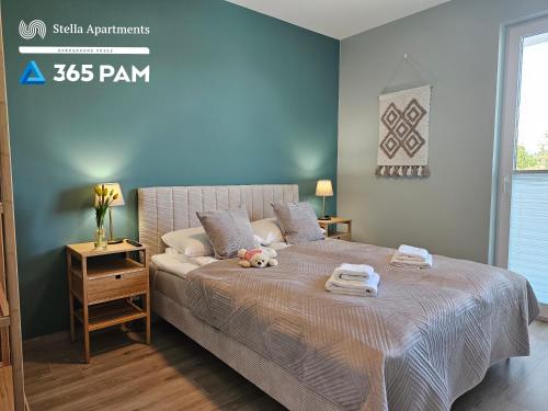 En eller flere senge i et værelse på Nadmorskie Apartamenty - 365PAM